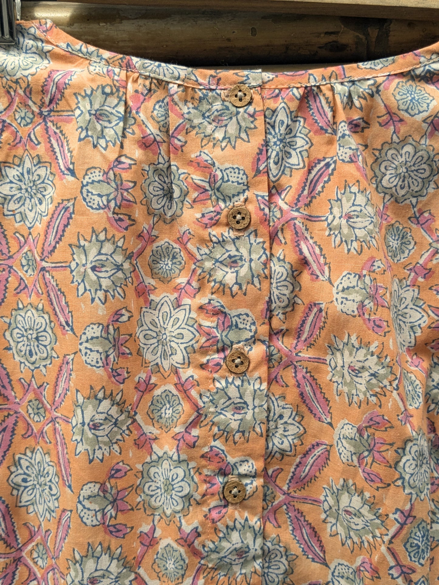 Girls sleeveless dress in orange and pink - closeup image