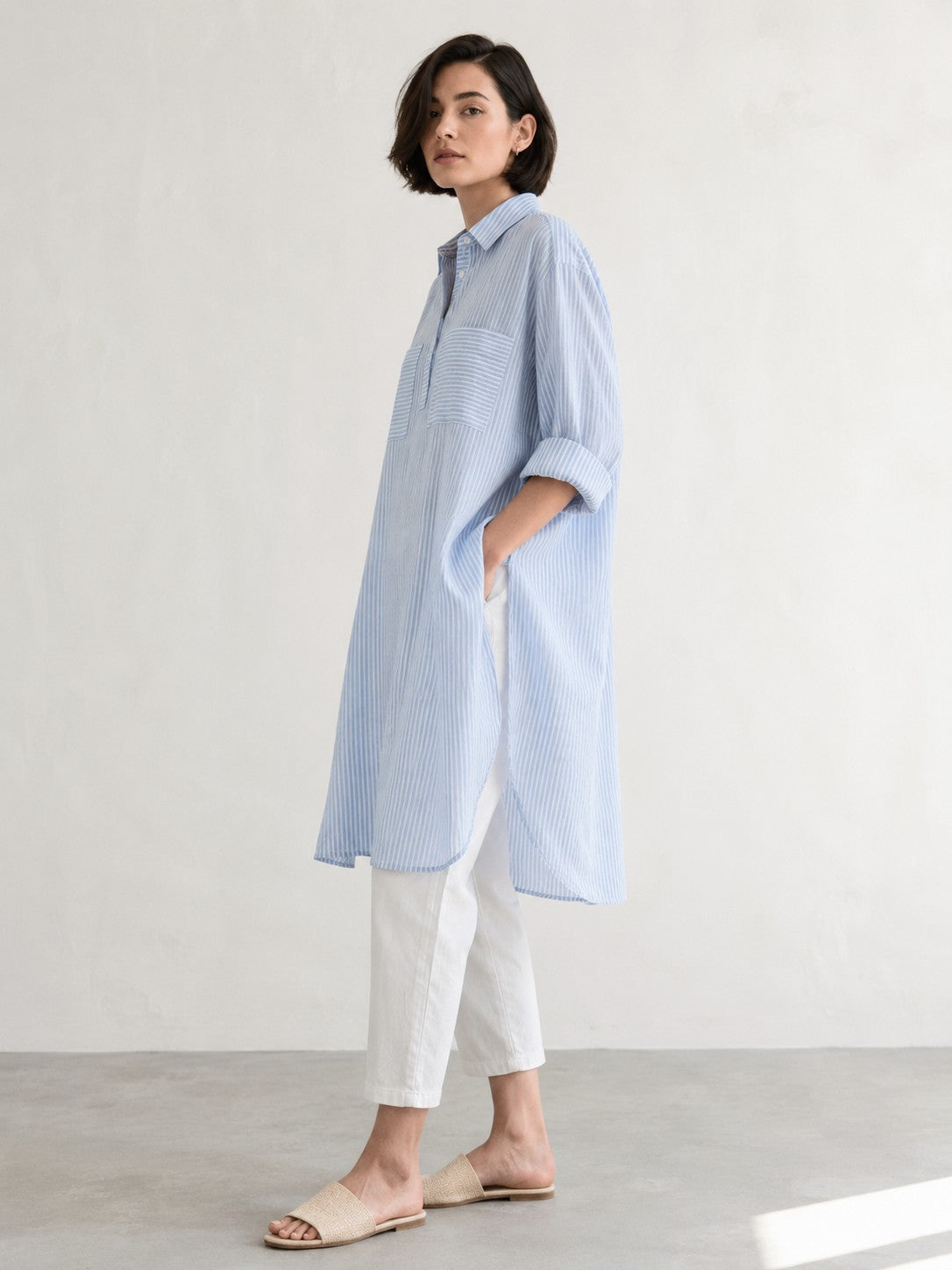 Women's oversized cotton kurta in light blue and white stripes with full sleeves, cuff and collar - model image