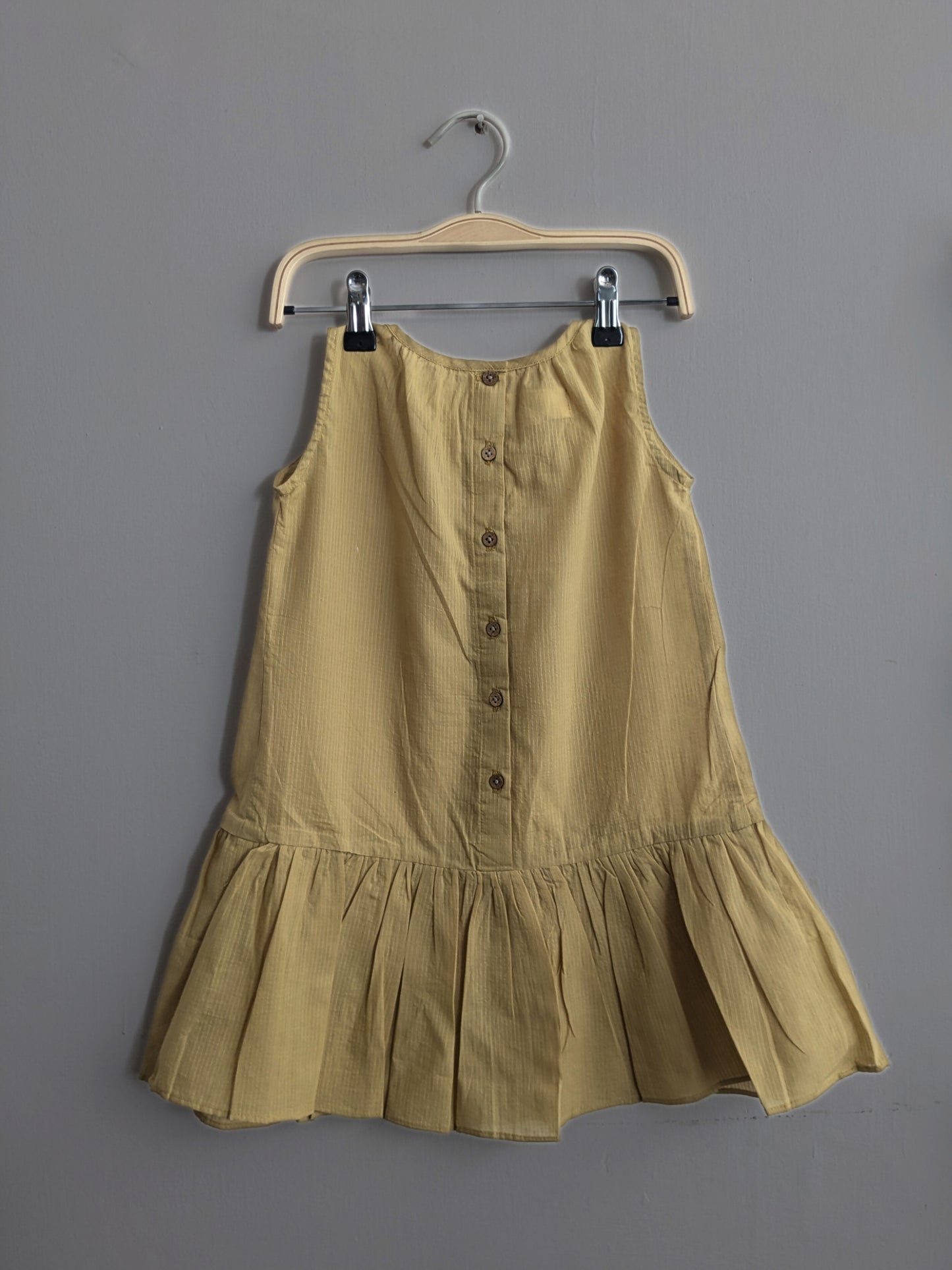 Girls sleeveless, knee length dress in yellow - Back image