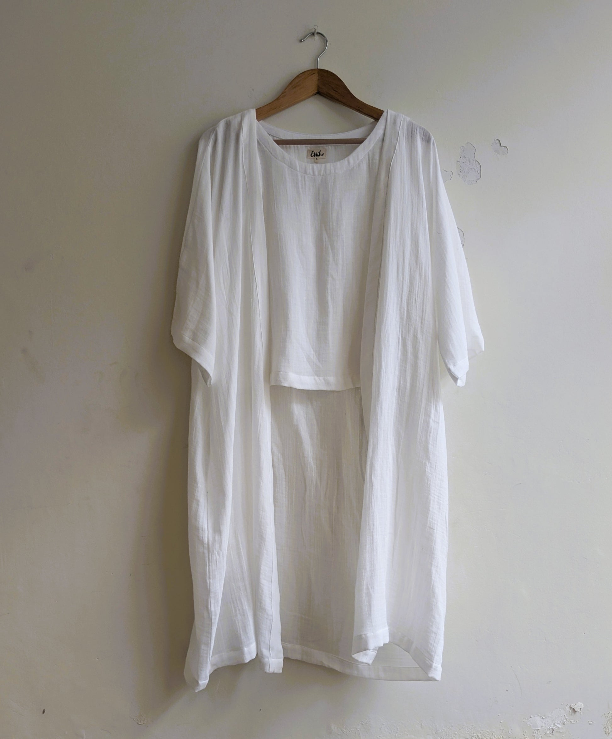 Women's dojo wrap in white cotton along with white sleeveless top inside  - Front Image