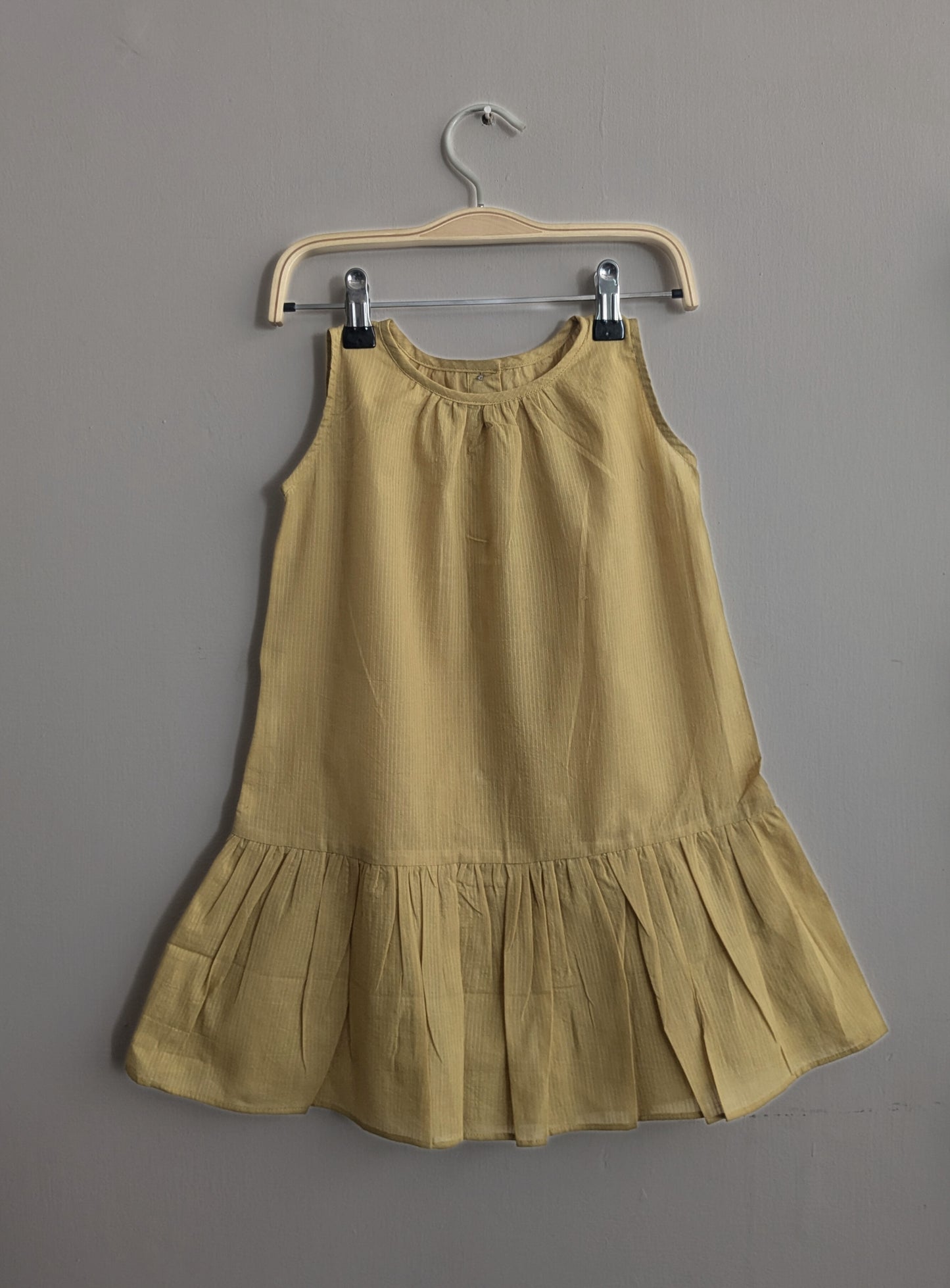 Girls sleeveless, knee length dress in yellow - Front image