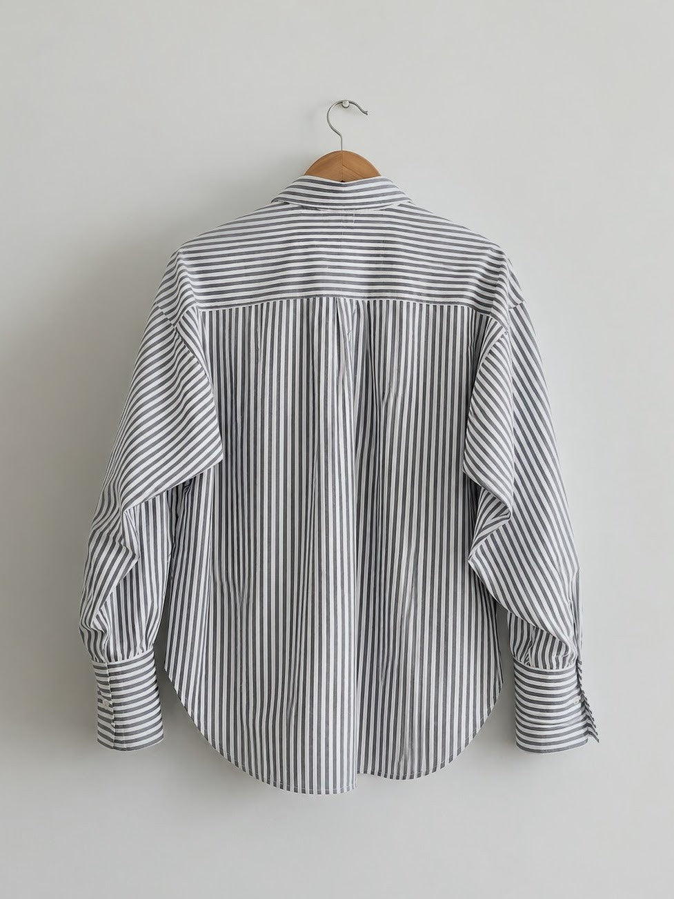 Women's oversized shirt in black and white stripes with full sleeves and  wider cuffs, features two pockets in the front  - back image