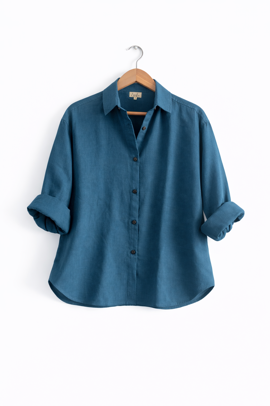 A women’s oversized full sleeve cotton gauze shirt in teal - Front image with sleeves rolled up