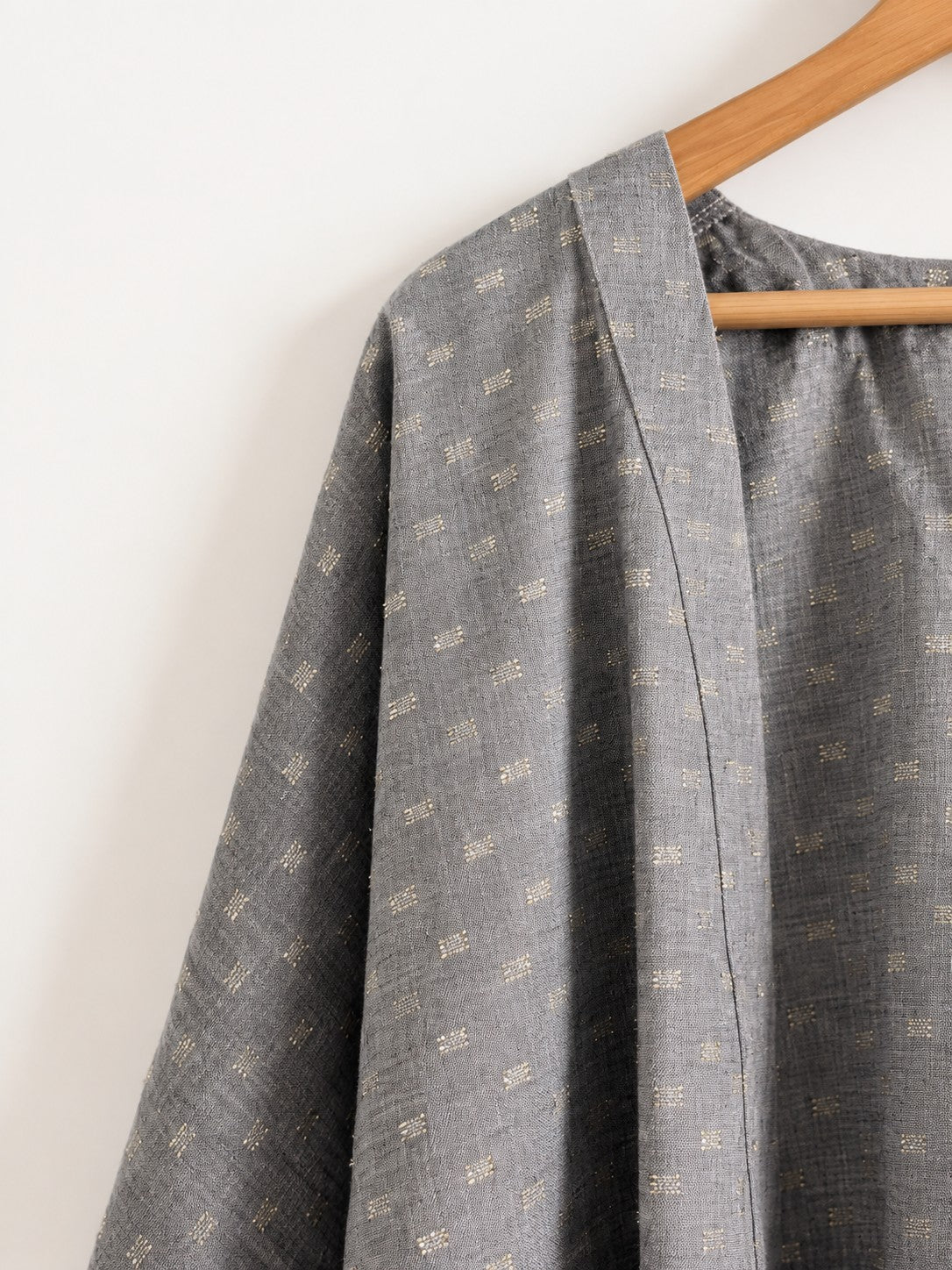 Women's jacket in grey and gold with kimono sleeves made with cotton linen - close up image