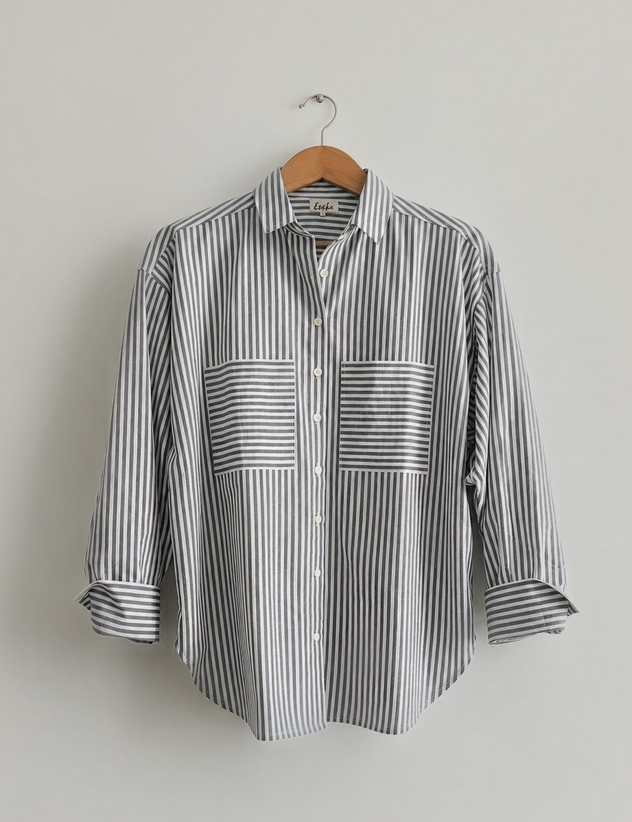 Women's oversized shirt in black and white stripes with full sleeves and  wider cuffs, features two pockets in the front  - front image